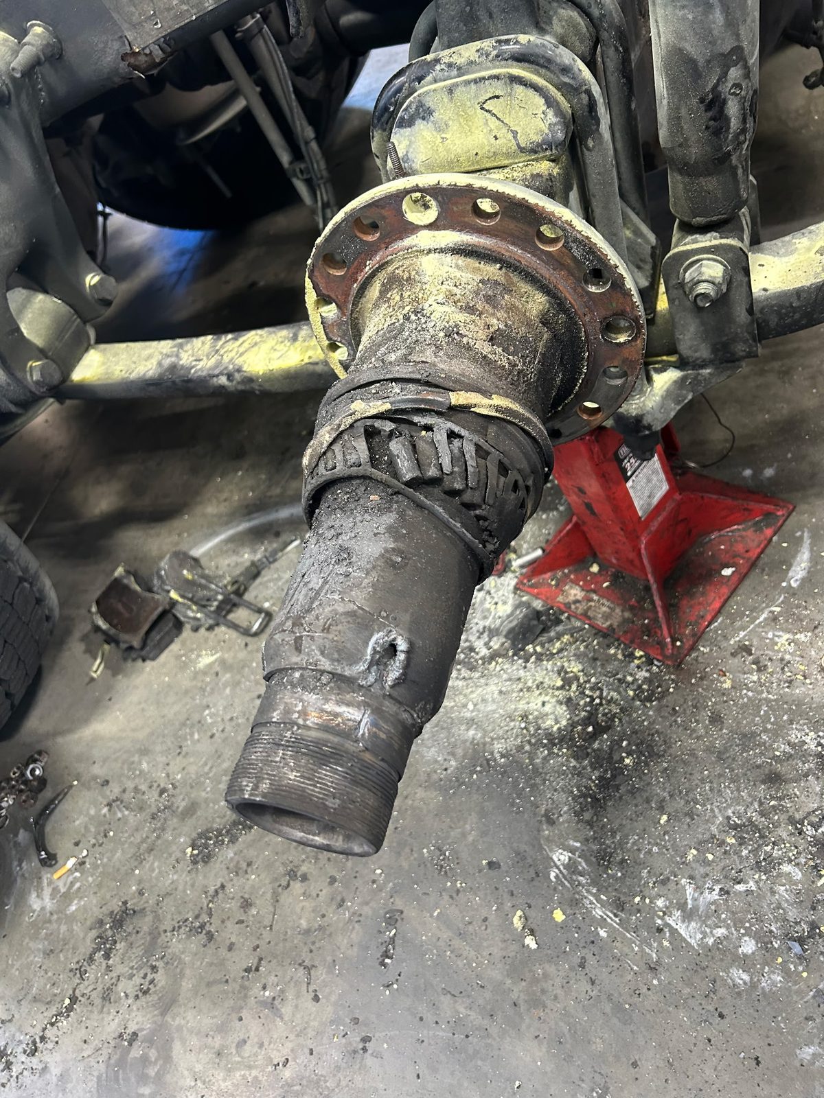 Damaged drive axle spindle before replacement, with the hub removed