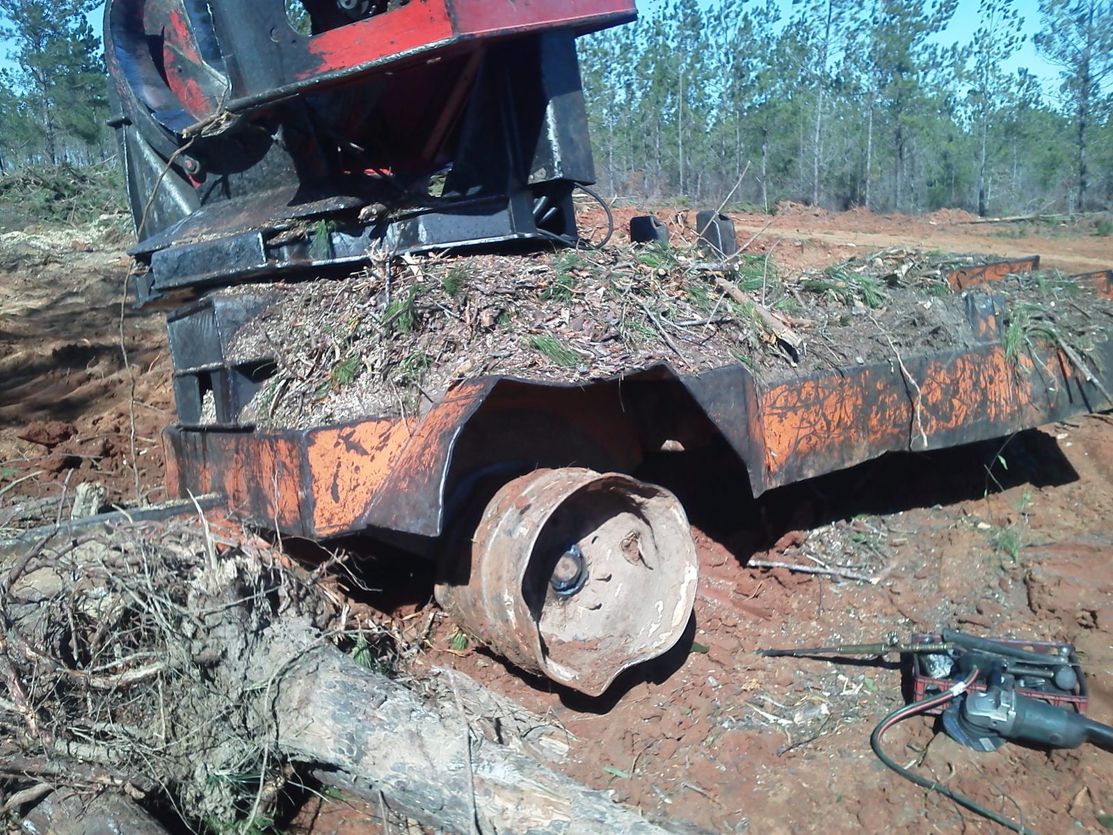 Heavy forestry equipment in the field during on-site spindle repair