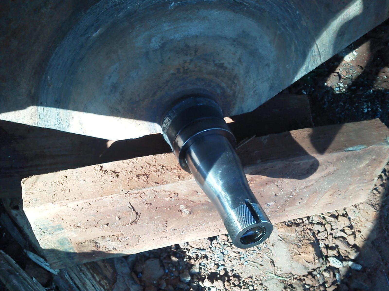 Close-up of a replacement spindle fitted to heavy forestry equipment