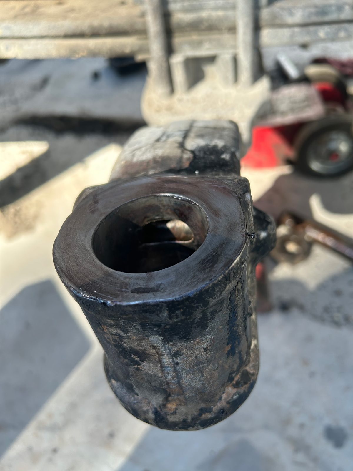 Worn steering axle eye before repair, showing the damaged bore