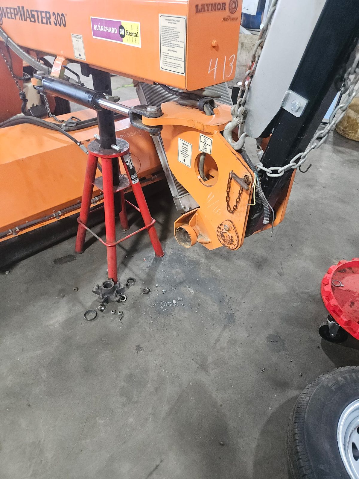 SweepMaster 300 street sweeper raised on stands for spindle repair