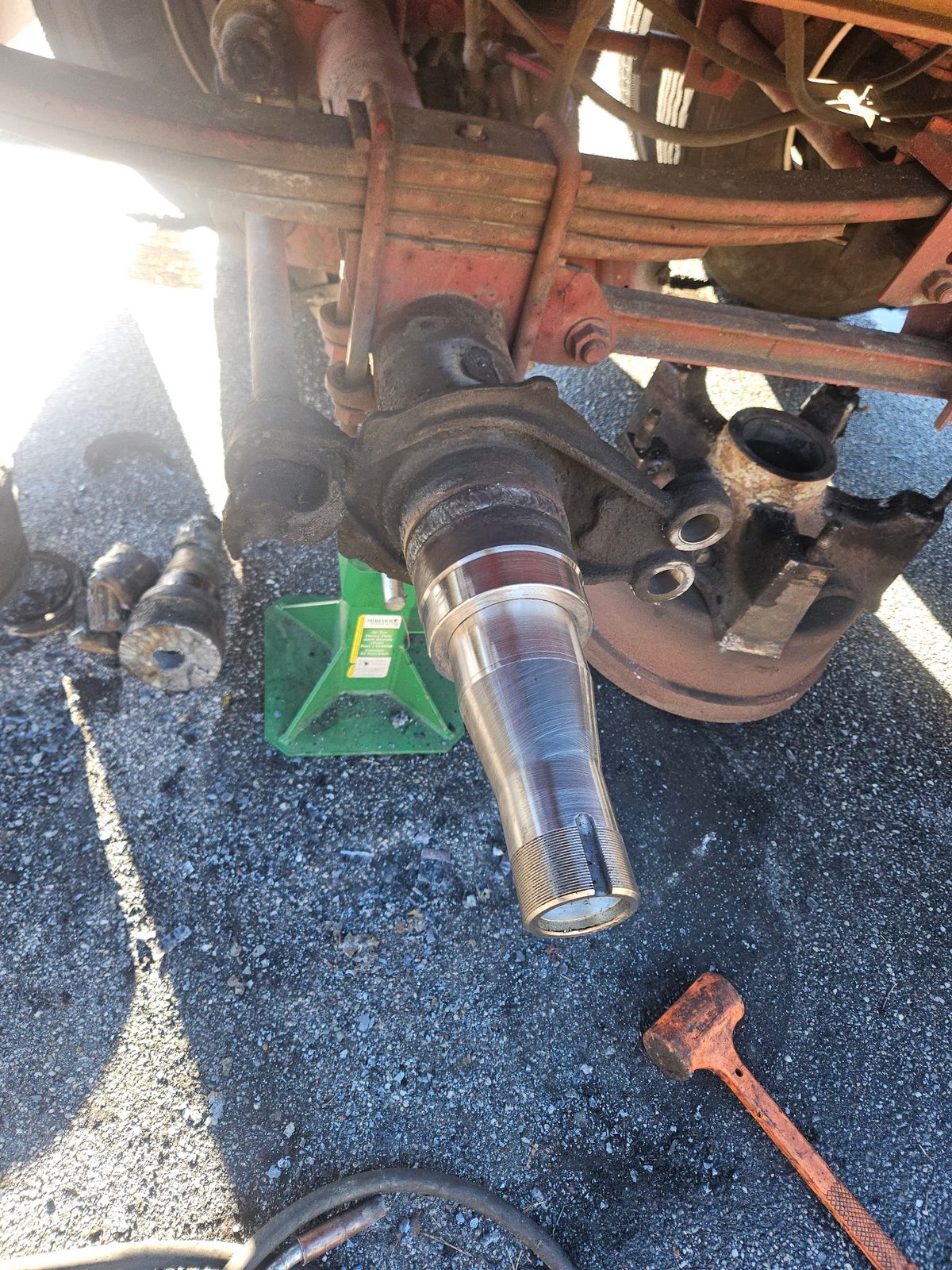 New trailer axle spindle installed after replacement