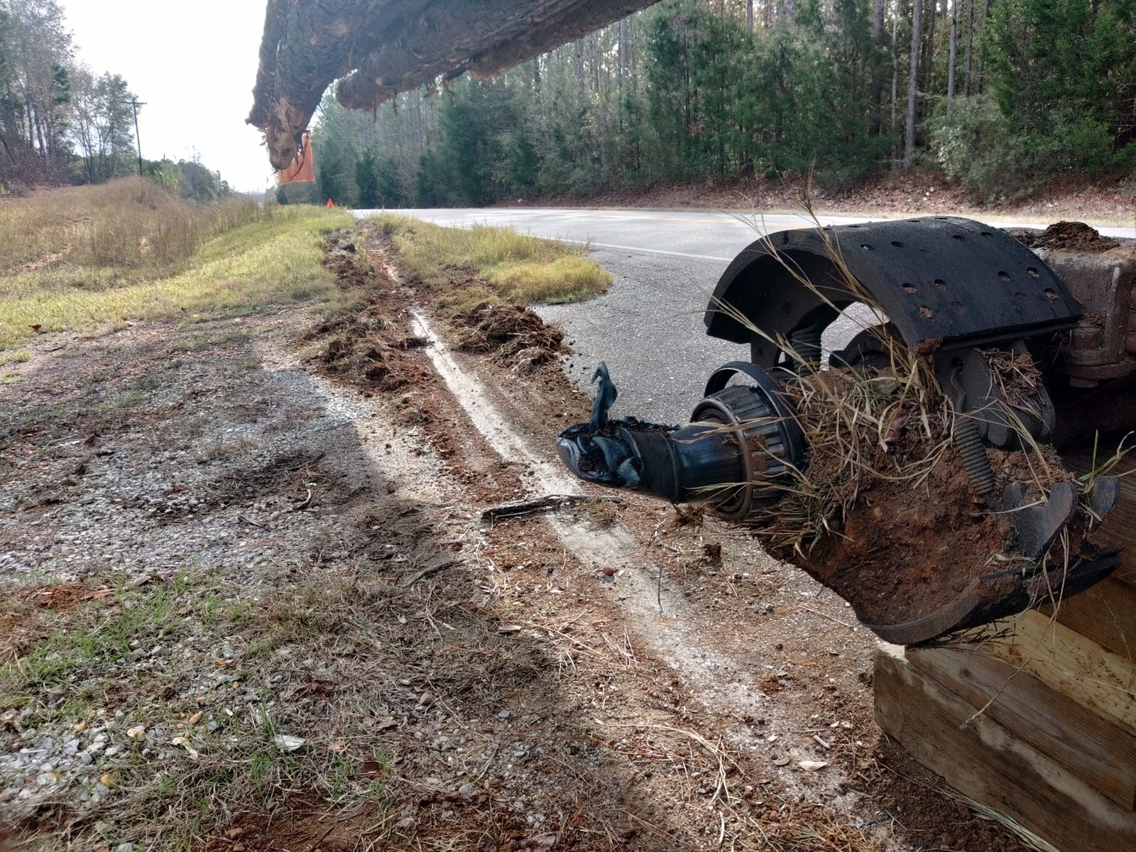 Logging trailer axle down at the roadside before spindle replacement